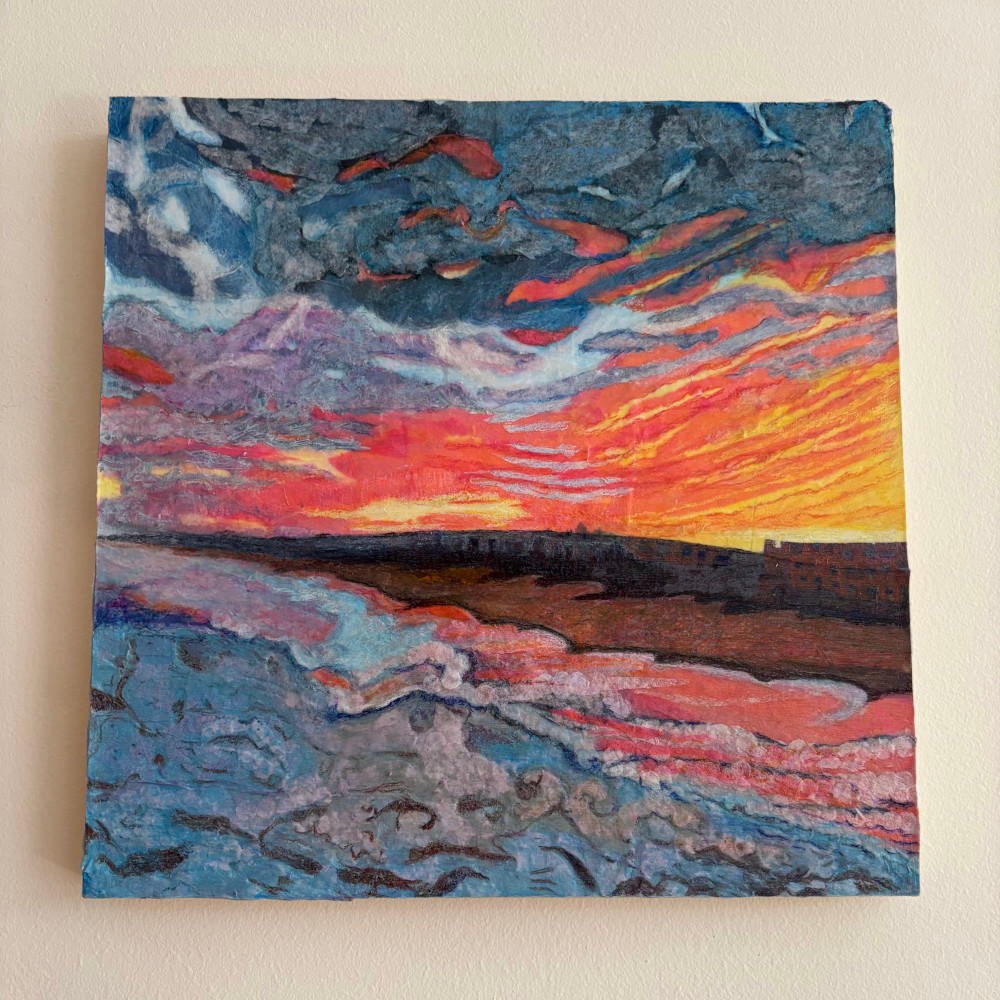 A piece depicting a sunset over a beach
